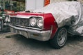 Classic American retro car under car case on the street. Bumper and headlight of red vintage car. Turkey, Cappadocia