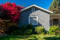 Classic American suburban house with a bright and vibrant flower garden in the front yard Royalty Free Stock Photo