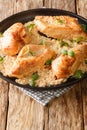 Classic Amish baked chicken breast with garlic and paprika close-up in a plate. vertical