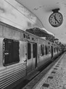 Classic analog clock and train at train station in Black and White. Concept for traveling & leisure by train