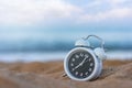 Classic analog clocks in sand on the tropical beach, Time concept