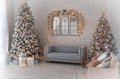 classic apartment with a white sofa decorated with wood, large windows and mirrors. Christmas evening by the light of garlands. Royalty Free Stock Photo
