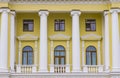 Classic architecture building exterior facade symmetry background yellow walls and white marble columns arch shape of window