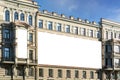 Classic architecture facade with ornate details and large blank billboard for mockup advertising in urban setting Royalty Free Stock Photo