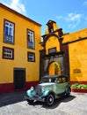 Classic Austin 12 Motor Car parked at Sao Tiago Fort: the pretty yellow fort at Funchal.