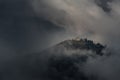 Classic Autumn Slovenian Landscape In Dark Colors With A Small Church On Top Of A Mountain Among Thunderclouds. Shot Near The Famo Royalty Free Stock Photo