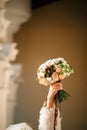 Classic autumn wedding bouquet in bridal`s hand close up.