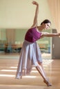 Classic ballet dancer posing at barre on rehearsal Royalty Free Stock Photo