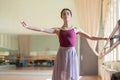 Classic ballet dancer posing at barre on rehearsal Royalty Free Stock Photo