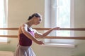 Classic ballet dancer posing at barre on rehearsal Royalty Free Stock Photo