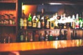 Classic bar counter with bottles in blurred background, copy space or space for text. colorful defocused background restaurant or Royalty Free Stock Photo