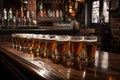 classic bar scene with row of draught beers and shot glasses on the counter