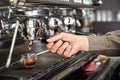 Classic barman hand preparing italian espresso at modern coffee