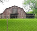 Classic barn with the red faded but still standing strong Royalty Free Stock Photo