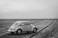 Classic beautiful white beetle car parked near the sea Royalty Free Stock Photo