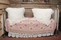 A classic bed in a rural setting with two pillows for sleeping Royalty Free Stock Photo