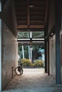 Classic bicycle leaning against a rustic wall in a rural barn Royalty Free Stock Photo