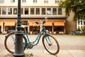 A classic bicycle parked at a pole on a street in Dresden