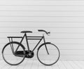 Classic black bike with white wall in 3D rendering