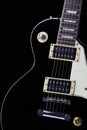 Classic black electric guitar body with white scratchplate Royalty Free Stock Photo