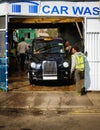 Classic black London taxi cab at the carwash