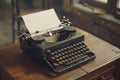 Classic black typewriter with empty paper Royalty Free Stock Photo