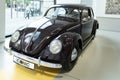 classic black vintage car Volkswagen VW Beetle pretzel, automotive nostalgia 1950s, display Iconic show Volkswagen Group Forum in