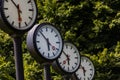 Classic black and white analog clocks with synchronized time show teamwork and synced project management with time management and