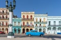 a classic blue american car driving past colorful buildings in old havana Royalty Free Stock Photo