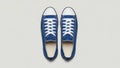 Classic blue canvas sneakers with white laces displayed on neutral background Royalty Free Stock Photo