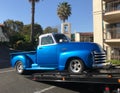Classic 1953 blue Chevy Truck on a flatbed tow truck