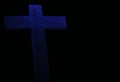 Classic blue Christian wood cross on dark background