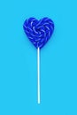 Classic Blue color of the Year 2020. Blue lollipop heart shaped on blue background. Candy. Love and sweet concept. Valentine day Royalty Free Stock Photo