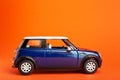 Classic Blue 2020 colored small toy car model on lush lava orange background. Travel concept colored in trendy colors. Vacation Royalty Free Stock Photo