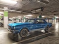 Classic blue Ford Mustang coupe veteran car parked in basement car park