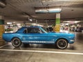 Classic blue Ford Mustang coupe veteran car parked in garage