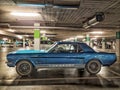 Classic blue Ford Mustang coupe veteran vintage car parked in garage