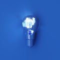 Classic Blue Light bulb Color Crack With Lighting glow on blue background.. Top view. 3D Render Royalty Free Stock Photo