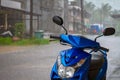 Classic blue motorbike on the rainy street of Thailand Royalty Free Stock Photo