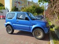 Small blue little 4WD Suzuki Jimny parked