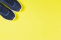 Classic blue sneakers on the yellow background. Concept for healthy lifestyle and everyday training