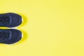 Classic blue sneakers on the yellow background. Concept for healthy lifestyle and everyday training