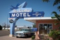 motel on historic Route 66 with a blue Hudson Hornet car at the door