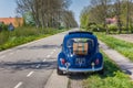 Classic blue Volkswagen beetle on a country road