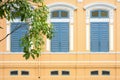 Classic blue wood window at the pale orange concrete building Royalty Free Stock Photo