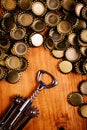 Classic bottle opener and pile of beer bottle caps