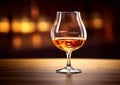 Classic brandy cognac glass on golden blurry background.Macro.AI Generative