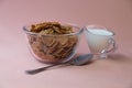 Classic breakfast flakes with milk on pink background