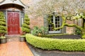 Classic brick house entrance with trim hedge