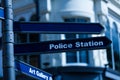 Classic Britain metal signpost three banners Police Station Art Gallery one blank to write in United Kingdom traditional